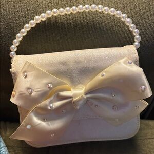 Claire's Cream Glitter Bow Bag